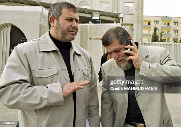 Senior Islamic Jihad leaders Nafez Azam and Khaled al-Batsh walk out after a meeting with Palestinian Prime Minister Ahmed Qorei in Gaza City, 30...