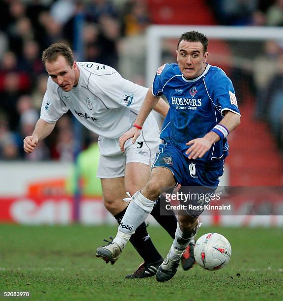 Henrik Pederson of Bolton challenges Lee Croft of Oldham during the FA Cup fourth round tie between Oldham Athletic and Bolton Wanderers at Boundary...