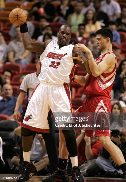 Shaquille O'Neal of the Miami Heat tangles with Yao Ming of the Houston Rockets on January 30, 2005 at the American Airlines Arena in Miami, Florida....