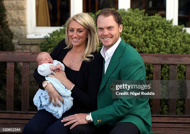 Masters champion Danny Willett poses for photographs wearing the famous green jacket with wife Nicole and son Zachariah at Lindrick Golf Club on...