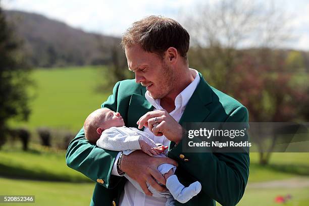 Masters champion Danny Willett poses for photographs wearing the famous green jacket with son Zachariah at Lindrick Golf Club on April 13, 2016 in...