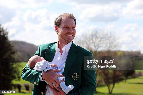 Masters champion Danny Willett poses for photographs wearing the famous green jacket with son Zachariah at Lindrick Golf Club on April 13, 2016 in...