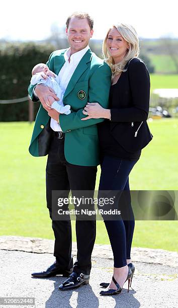 Masters champion Danny Willett poses for photographs wearing the famous green jacket with wife Nicole and son Zachariah at Lindrick Golf Club on...