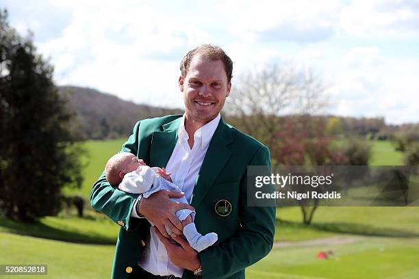 Masters champion Danny Willett poses for photographs wearing the famous green jacket with son Zachariah at Lindrick Golf Club on April 13, 2016 in...