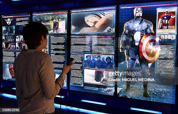 Visitor looks at a display on Marvel Comics superhero "Captain America" at the interactive Marvel Avengers STATION exhibition in the bussines...