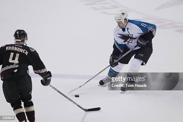 Center Owen Nolan of the San Jose Sharks skates with the puck during game two of the Western Conference Stanley Cup playoffs against the Phoenix...