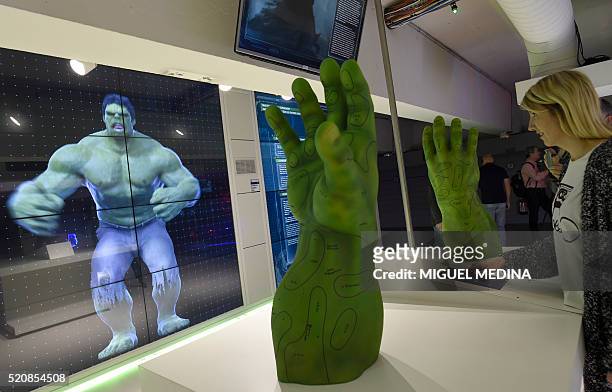 Visitor tries out an interactive display on Marvel Comics superhero "The Hulk" at the interactive Marvel Avengers STATION exhibition in the bussines...