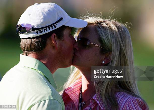 Justin Leonard gets a kiss from his wife Amanda on the 18th hole in celebration of his win during the final round of the Bob Hope Classic at the PGA...