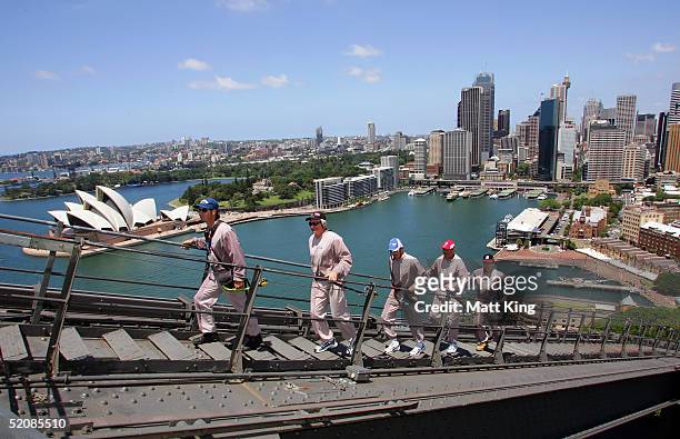Coaches Mark Harvey, Paul Roos, Dean Laidley and Mick Malthouse follow an unidentified guide as they climb the Sydney Harbour Bridge for an AFL...