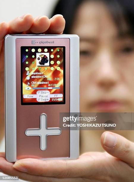 Japan's electronics giant Toshiba employee Junko Furuta displays the company's latest audio player "gigabeat F60", equipped with a 60GB harddisk...