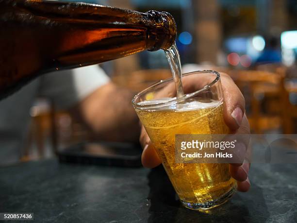 pouring a beer in a rio de janeiro bar. - beer drinking stock pictures, royalty-free photos & images