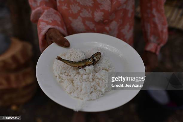 Farmer showing her plate of rice and dried fish in Arakan on April 8, 2016 in Cotabato, Mindanao, Philippines. The heatwave brought on by the El Nino...