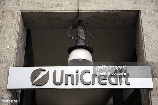 UniCredit SpA logo sits above the entrance to a bank branch in Milan, Italy, on Wednesday, April 13, 2016. The latest plan to address Italian banks'...