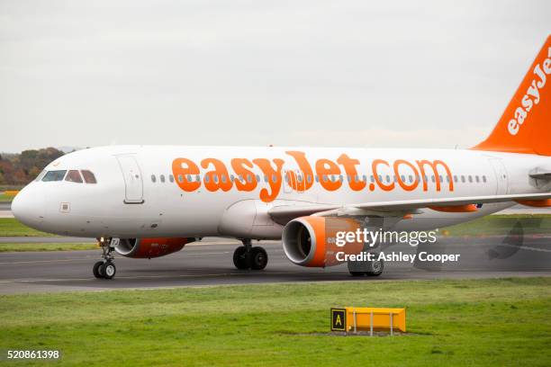 an easyjet plane taxiing towards the runway at manchester airport, uk. - easyjet stock pictures, royalty-free photos & images