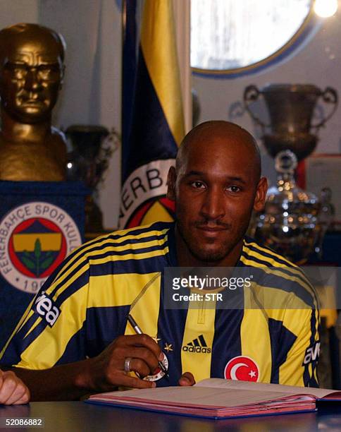 French player Nicolas Anelka wearing Fenerbahce's shirt signs his contract during the signing up ceremony at the club's headquaters in Istanbul 31...