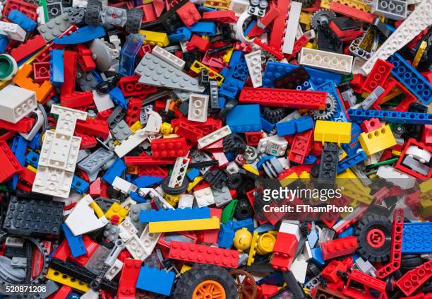 cluttered pile of many colourful lego bricks - lego blocks stock pictures, royalty-free photos & images