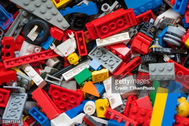 cluttered pile of many colourful lego bricks - plastic block stock pictures, royalty-free photos & images