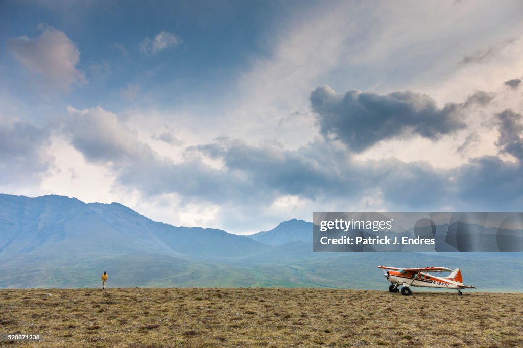 Bush plane and pilot on Arctic tundra