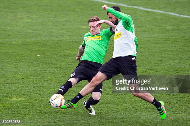 Andre Hahn and Martin Stranzl battle for the ball during a Borussia Moenchengladbach training session at Borussia-Park on April 13, 2016 in...