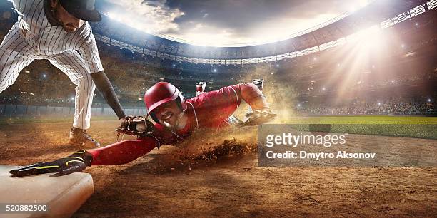 sliding and tagging on third base - baseball sport stock pictures, royalty-free photos & images