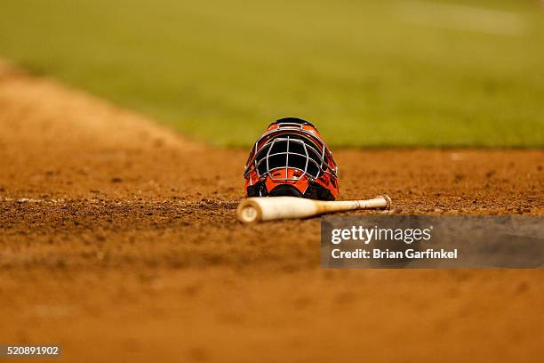 San Francisco Giants catchers mask and a wood bat lay on the dirt during the game against the Philadelphia Phillies at Citizens Bank Park on June 5,...