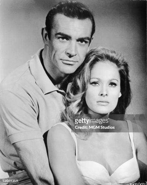 Scottish actor Sean Connery, as fictional secret agent James Bond, and Swiss actress Ursula Andress pose together in a promotional still for the film...