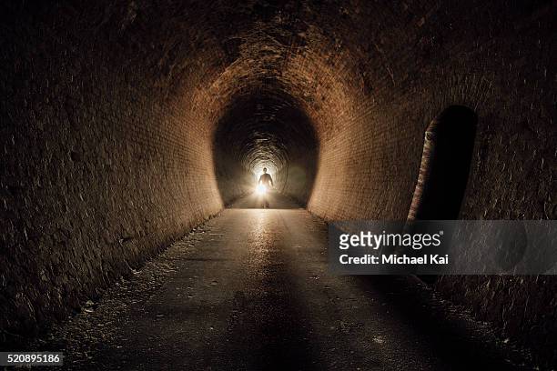 person with touch in old cheviot railway tunnel in yea - torcia elettrica foto e immagini stock