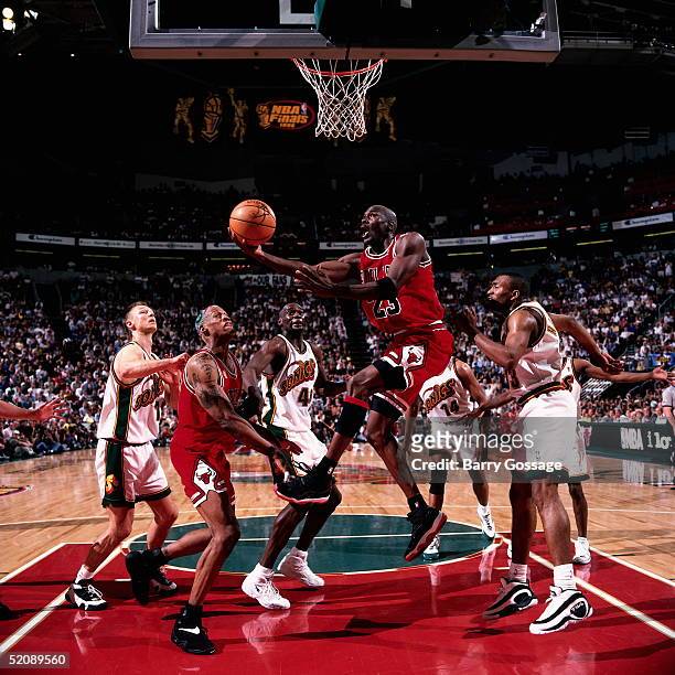 Michael Jordan of the Chicago Bulls drives to the basket for a reverse layup against the Seattle Sonics during Game four of the 1996 NBA Finals at...