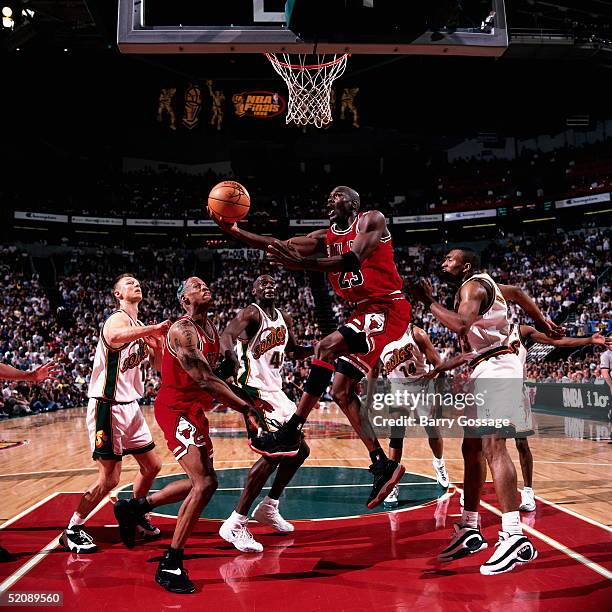 Michael Jordan of the Chicago Bulls drives to the basket for a reverse layup against the Seattle Sonics during Game four of the 1996 NBA Finals at...