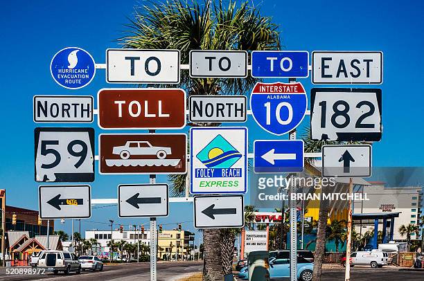 multiple road signs, gulf shores, alabama, usa - wegwijzer stockfoto's en -beelden