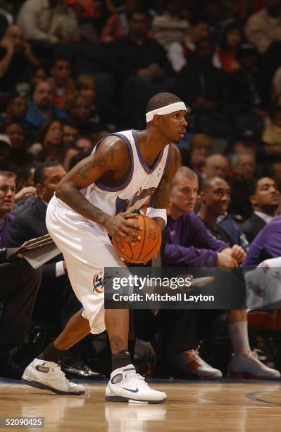 Larry Hughes of the Washington Wizards attempts to pass the ball against the Phoenix Suns during the game on January 15, 2005 at the MCI Center in...