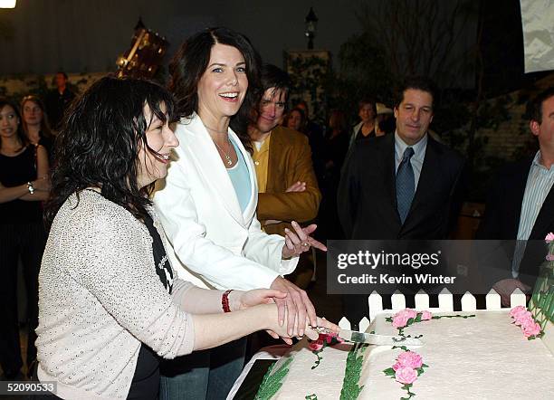 Creator and producer Amy Sherman-Palladino and actress Lauren Graham cut the cake at The WB Networks "The Gilmore Girls" 100th episode celebration on...