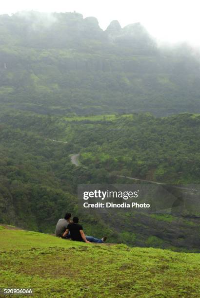 friends enjoying in rainy season, malshej ghat, maharashtra, india - malshej ghat stock-fotos und bilder