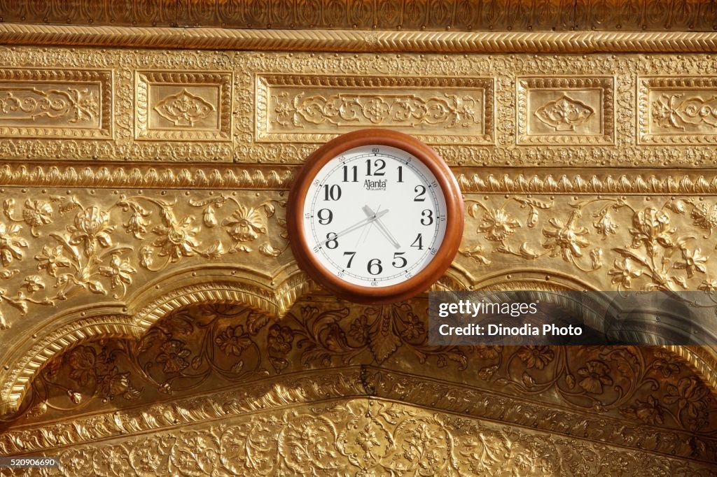 Wall clock at Harmandir Sahib or Darbar Sahib Golden Temple in Amritsar, Punjab, India