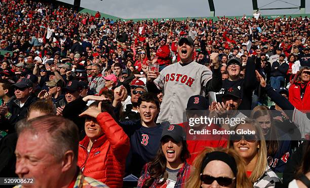 Tim Gagne of Newton cheers after the Red Sox scored a run during their Home Opener at Fenway Park in Boston, Mass. On April 11, 2016.