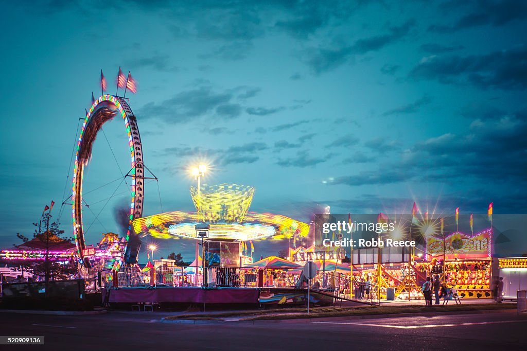 American amusement park evening scene with lights and motion