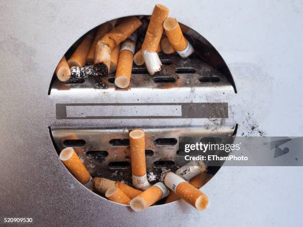 cigarettes in an ashtray - aschenbecher stock-fotos und bilder