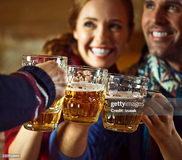 friends toasting with beer - après ski stockfoto's en -beelden