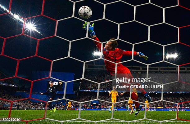 Atletico Madrid's French forward Antoine Griezmann scores a goal past Barcelona's German goalkeeper Marc-Andre Ter Stegen during the Champions League...