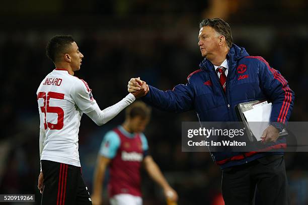 Louis van Gaal, manager of Manchester United shakes hands with Jesse Lingard of Manchester United after the Emirates FA Cup, sixth round replay...