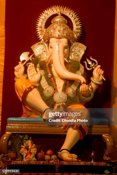 idol of lord ganesh with simple decoration pune maharashtra - ganesha stock pictures, royalty-free photos & images