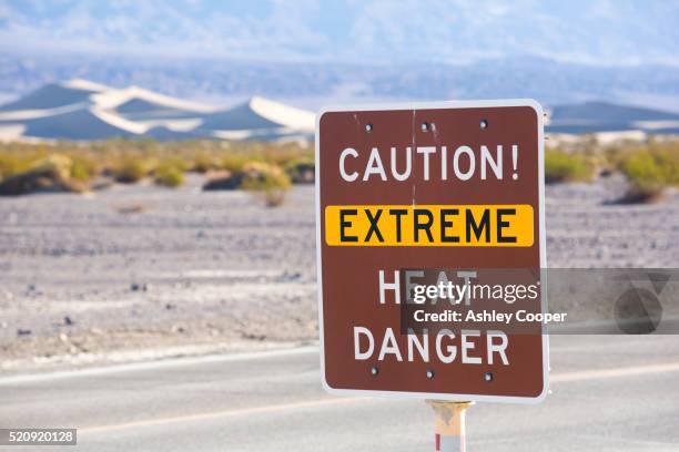 an extreme heat danger sign in death valley which is the lowest, hottest, driest place in the usa - cooper basin stock pictures, royalty-free photos & images