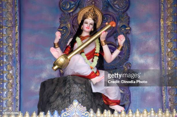 idol of saraswati playing musical instrument at pune, maharashtra, india, asia - saraswati stock-fotos und bilder