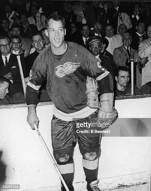 Gordie Howe of the Detroit Red Wings celebrates after his 545th goal and breaking the NHL goal scoring record during a game against the Montreal...