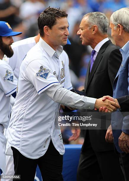 Jason Frasor of the Kansas City Royals is congratulated after receiving his World Series Championship ring prior to a game against the New York Mets...