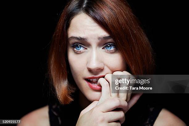 woman looking worried - nail biting stock pictures, royalty-free photos & images