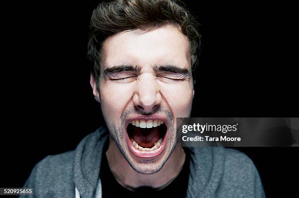 man shouting into camera - someone shouting stock pictures, royalty-free photos & images