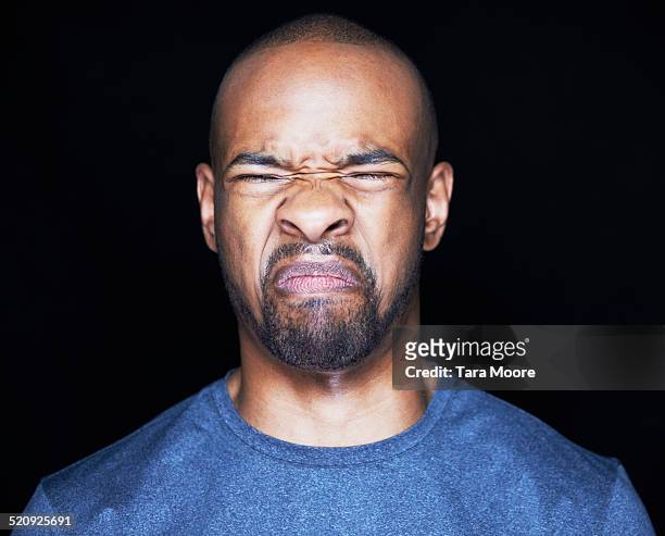 man grimacing - offense stock pictures, royalty-free photos & images