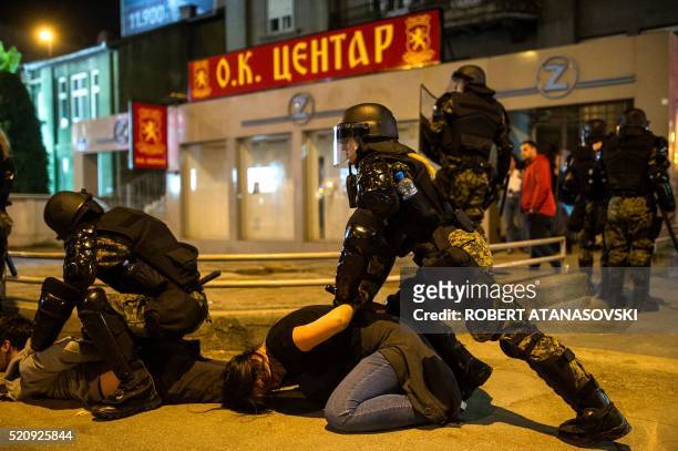 Police officers arrest protesters in central Skopje on April 13 as several thousand people took the streets to demand the resignation of President...