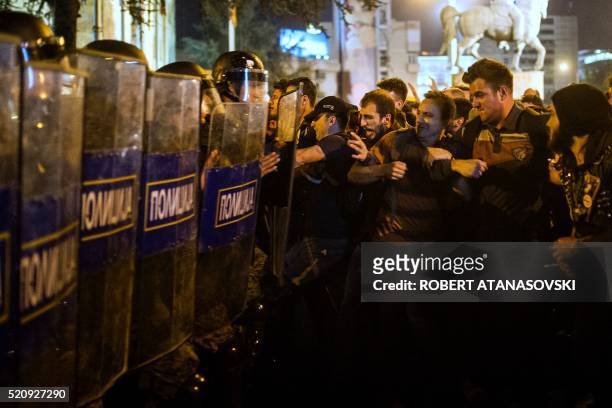 Protesters clash with anti-riot police officers in Skopje on April 13, 2016 during a protest to demand the resignation of President Gjorge Ivanov...